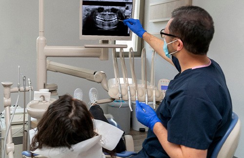 Dentist showing patient her dental x-rays