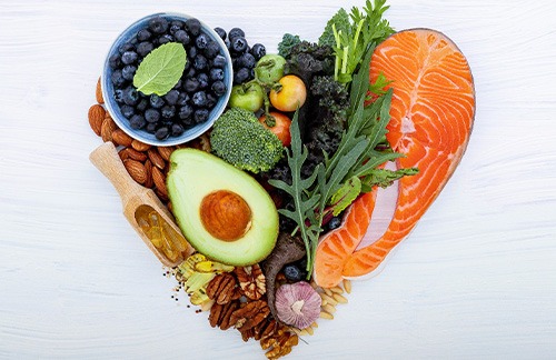 Healthy foods on a white table in the shape of a heart