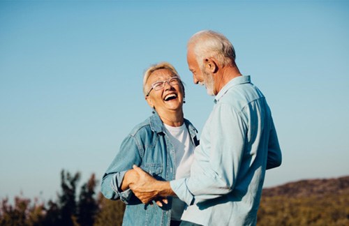 Senior couple smiling together outside