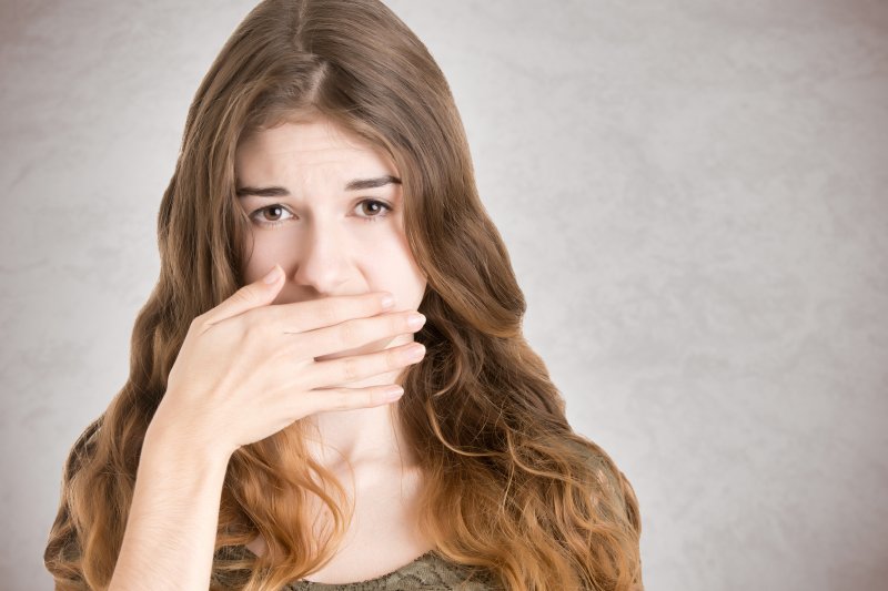 Woman covering her mouth